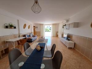 sala de estar con mesa azul y sillas en Villa Mariamar, en Albufeira