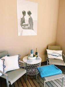 a room with two chairs and a table and a picture at Portopiccolo Avolare Apartments in Sistiana