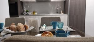 a table with a plate of pastries and blue cups at Castelo Terrace Apartement in Leiria