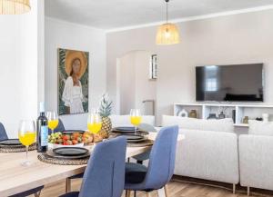 a dining room and living room with a table and chairs at Villa Coral - Private Large Pool & Garden in Famalicão