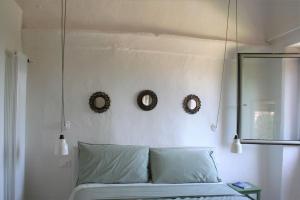 a bedroom with two wreaths on the wall and a bed at Casa Ninetta, tra mare e natura. in Finale Ligure