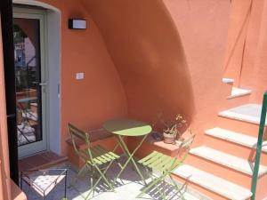 a table and chairs sitting outside of a building at Casa Ninetta, tra mare e natura. in Finale Ligure