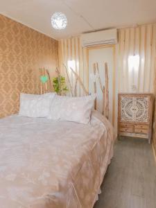 a bedroom with a white bed and a table at AzulZenLodge in Paine