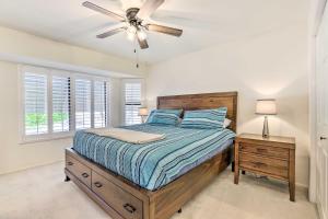 a bedroom with a bed and a ceiling fan at Less Than 1 Mi to Golf Home with Screened Porch in Sun City in Sun City West