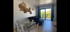 a living room with a table and a blue couch at La Mundial Formentera in Es Pujols +20 photos