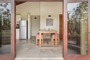 a kitchen with a table and a refrigerator at The Natural Curacao in Willibrordus