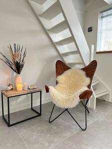 een woonkamer met een stoel en een tafel bij The Lighthouse Cabin in Noordwijk
