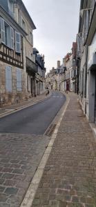 an empty street in an old town with buildings at CAPUCINE in Bourges