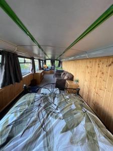 a bed in the inside of a bus at Bus and the lodge With space and views in Bladon