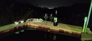 a table with two glasses of wine and cheese at Glamping MINKAWAY in Santa Marta +11 photos