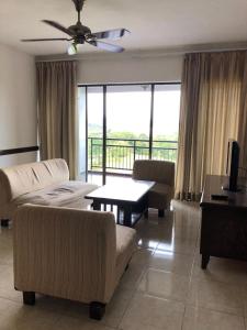 a living room with a couch and chairs and a table at Aisis Home at Afamosa in Kampong Alor Gajah
