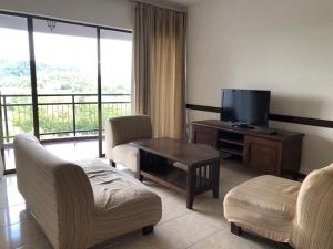 a living room with a television and a table and chairs at Aisis Home at Afamosa in Kampong Alor Gajah