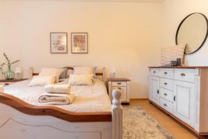 a bedroom with a bed with a mirror and a dresser at Villa Venus in Willendorf in der Wachau