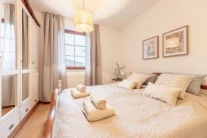 a large white bed in a room with a window at Villa Venus in Willendorf in der Wachau