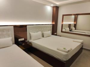 Postel nebo postele na pokoji v ubytování Hotel Apple Villa - New Delhi