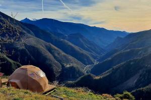 a tent on top of a mountain overlooking a valley at Les 3 Flocons Roure in Roure