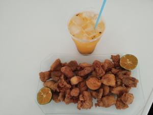 a plate of food with tater tots and a drink at Pousada Vida feliz in Águas de Lindoia