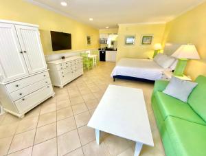 a living room with a bed and a couch at Island Inn of Atlantic Beach in Atlantic Beach