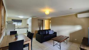 sala de estar con sofá y mesa en 2 Bedroom 3 Bed Villa Inner City, en Toowoomba