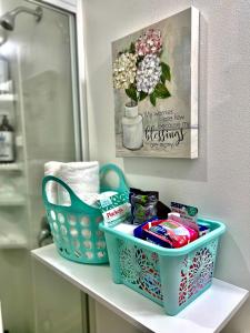 a bathroom shelf with a basket of toiletries and a mirror at Micro Studio Apartment 10 Minutes Walk to University of Washington in Seattle