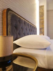 a bed with a headboard and a pillow and a lamp at Panorama Suite in Piazza Armerina