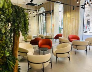 a room with chairs and tables in a building at Hotel Central Basilica in Budapest