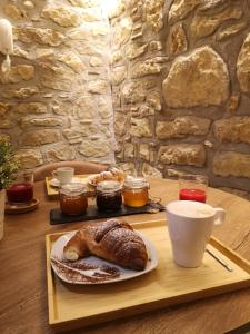 a table with a plate of bread and a cup of coffee at Panorama Suite in Piazza Armerina