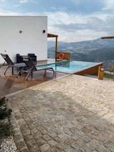 a house with a swimming pool and chairs on a roof at DOURO BROTHERS in Resende