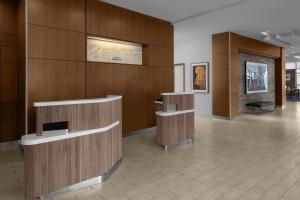 a lobby with wood paneled walls and a fireplace at Courtyard Cleveland University Circle in Cleveland