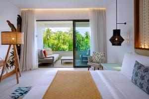 a bedroom with a bed and a living room at laïla, Seychelles, a Marriott Tribute Portfolio Resort in Mahe