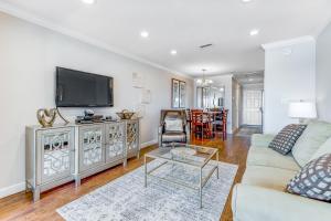 a living room with a couch and a tv at Sunset Harbor Palms 2-304 in Navarre