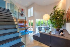 a living room with a glass wall at Fascinating Luxe Two-Level Villa BY THE GLAMHOMES in Biscayne Park