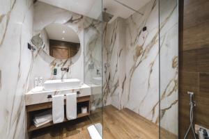 a bathroom with a sink and a mirror at Bristol Hotel Podgorica in Podgorica