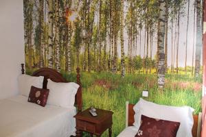 a bedroom with a mural of trees and grass at Franca in Porto