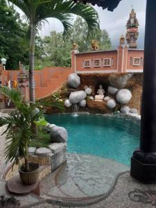 a small swimming pool in a house with a waterfall at Villa Manouria - Marcel in Padangbai