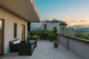 a balcony with chairs and tables on a building at Milan Marriott Hotel in Milan