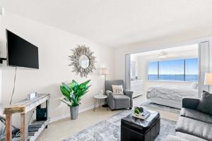 a living room with a bed and a tv at Sunset Harbor Palms 1-308 in Navarre