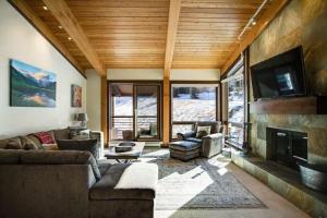 a living room with a couch and a fireplace at Snowmass Village, 3 Bedroom at the Enclave - Ski-in Ski-out with Airport Transfers in Snowmass Village