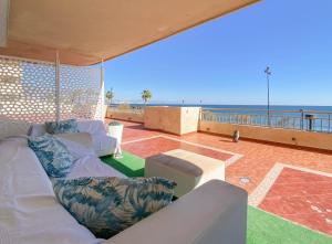 a living room with couches and a view of the ocean at Luxury beachfront, free private parking in Fuengirola