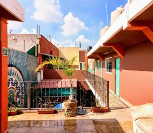 a balcony with potted plants on a building at WHOST Hotel y Hostal in Mexico City