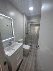 a bathroom with a sink and a toilet and a shower at Cabopino Beach & Marina Apartment in Marbella