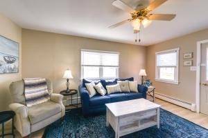 a living room with a blue couch and chairs at Cozy Villas Cottage with Deck, half Block to Beach! in Villas