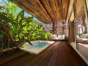 a hot tub in the middle of a room with plants at Hotel Shibari - Restaurant & Cenote Club in Tulum