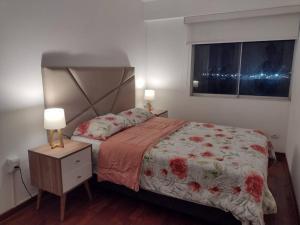 a bedroom with a bed and a nightstand and a window at Apartment 4 Rent - Av. San Borja Norte Cdra 7 in Lima