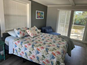 a bedroom with a bed and a chair and a window at Angler's Inn in Matlacha