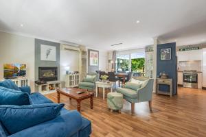 a living room with a blue couch and chairs at Swanbrook in Mount Victoria