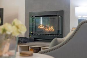 a fireplace in a living room with a fire in it at Swanbrook in Mount Victoria