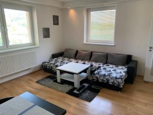 a living room with a couch and a table at Feel Good Apartment in Detva