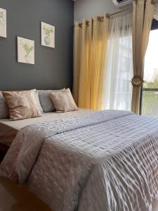 a bedroom with a large bed and a window at Aquaview in Bijilo