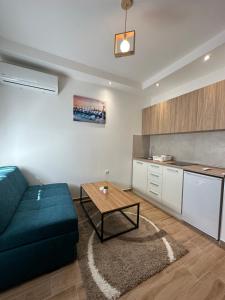 a living room with a blue couch and a table at DREAM apartments in Niš